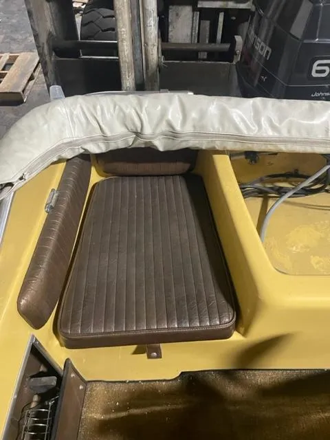 Slide: The Image of 1977 Yarcraft Spirit of 76 boat interior with brown leather seating and yellow accents. - 10