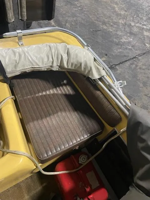 Slide: The Image of 1977 Yarcraft Spirit of 76 boat interior with brown seating and red fuel tank. - 13