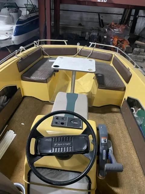 Slide: The Image of 1977 Yarcraft Spirit of 76 boat interior with steering wheel and seating area. - 14