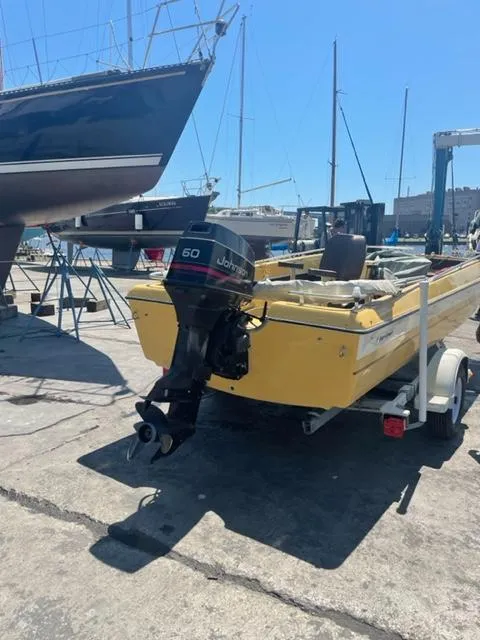 Slide: The Image of Yellow 1977 Yarcraft Spirit of 76 boat with Johnson 60 outboard motor on trailer. - 3