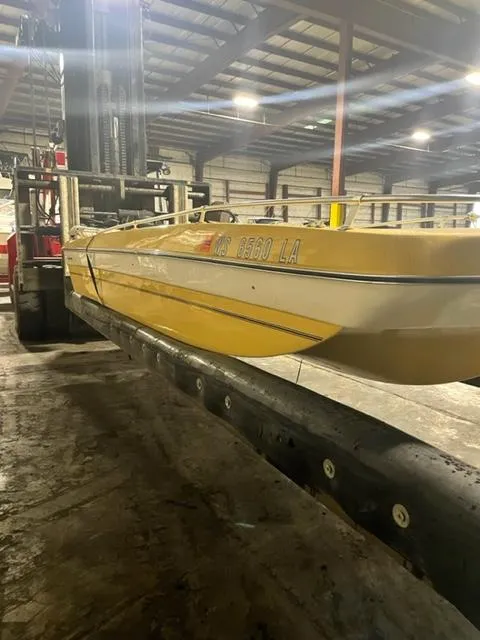 Slide: The Image of 1977 Yarcraft Spirit of 76 boat on forklift in warehouse setting. - 4