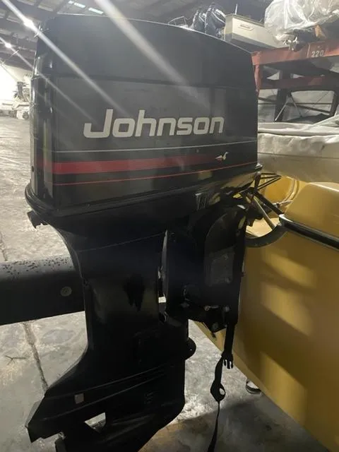 Slide: The Image of 1977 Yarcraft Spirit of 76 with Johnson outboard motor in a garage setting. - 7