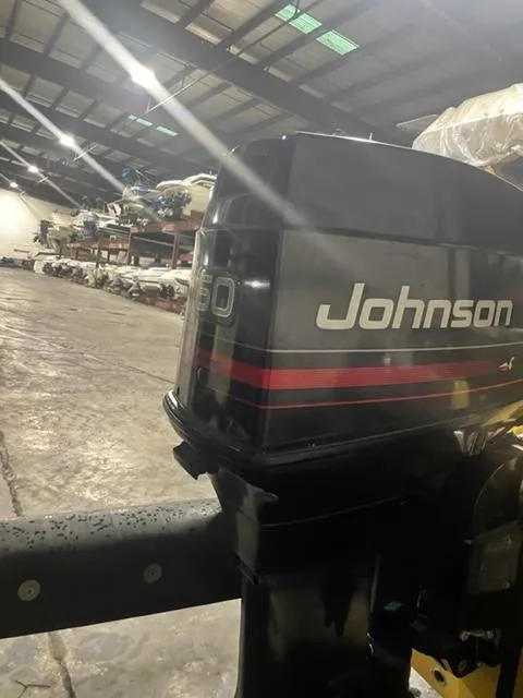 Slide: The Image of 1977 Yarcraft Spirit of 76 with Johnson outboard motor in a warehouse. - 8