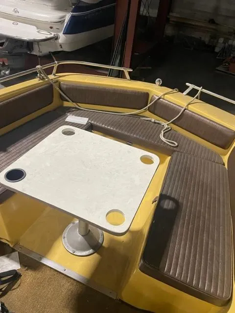 Slide: The Image of 1977 Yarcraft Spirit of 76 boat interior with yellow seating and a white table. - 9