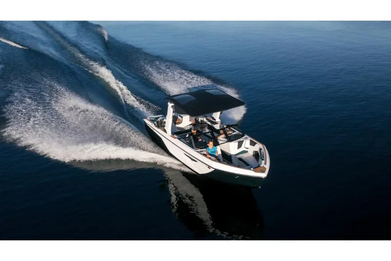Slide: The Image of 2023 Nautique Super Air Nautique S25 cruising on water. - 10