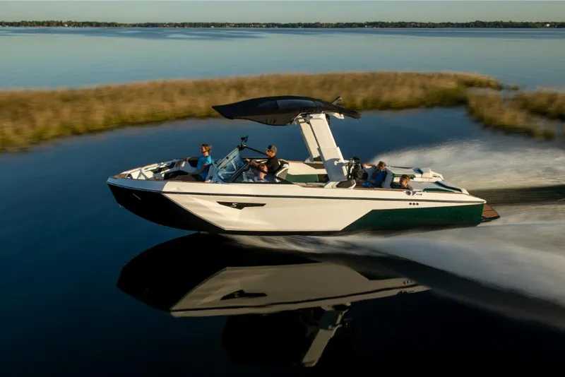 Slide: The Image of 2023 Nautique Super Air Nautique S25 cruising on a serene lake. - 13