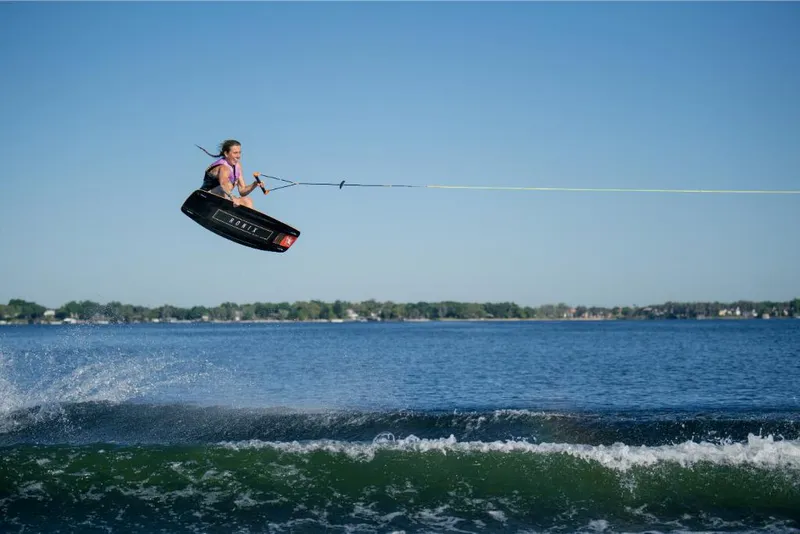 Slide: The Image of Person wakeboarding behind 2023 Nautique Super Air Nautique S25 on a sunny day. - 15