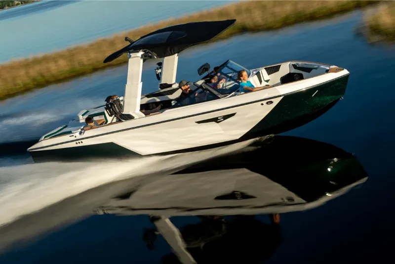 Slide: The Image of 2023 Nautique Super Air Nautique S25 speeding on a lake with passengers. - 16