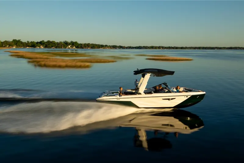 Slide: The Image of 2023 Nautique Super Air Nautique S25 speeding on a calm lake. - 22