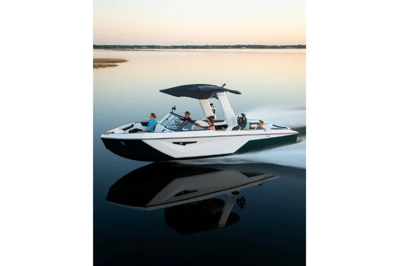 Slide: The Image of 2023 Nautique Super Air Nautique S25 cruising on calm water at sunset. - 26