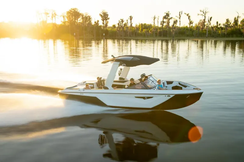 Slide: The Image of 2023 Nautique Super Air Nautique S25 cruising on a lake at sunset. - 3