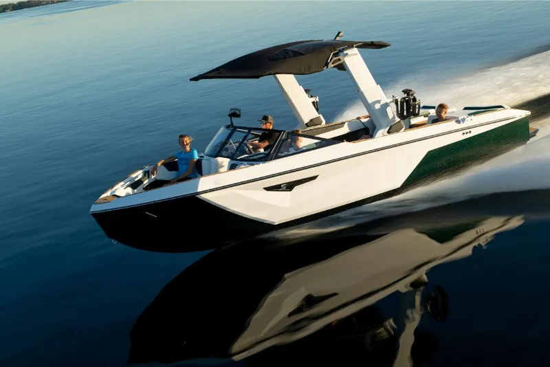 Slide: The Image of 2023 Nautique Super Air Nautique S25 speedboat cruising on a calm lake. - 31