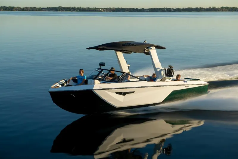 Slide: The Image of 2023 Nautique Super Air Nautique S25 cruising on a calm lake. - 32