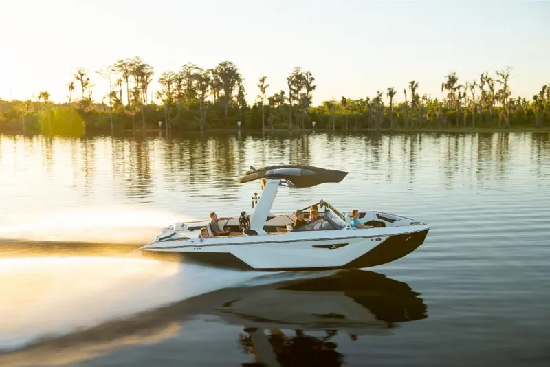 Slide: The Image of 2023 Nautique Super Air Nautique S25 speeding on a serene lake at sunset. - 37