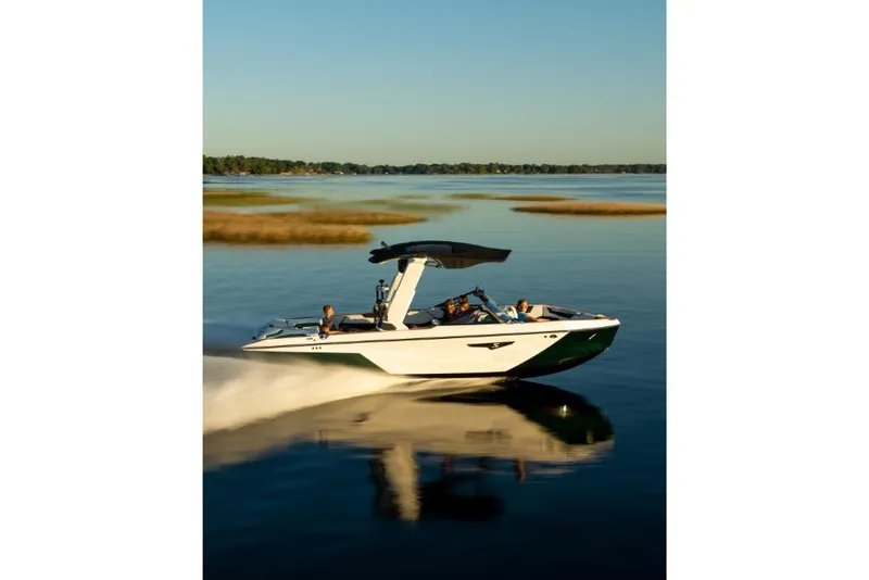 Slide: The Image of 2023 Nautique Super Air Nautique S25 cruising on a calm lake. - 44
