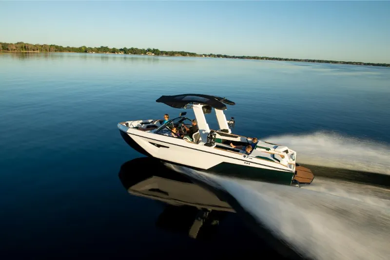 Slide: The Image of 2023 Nautique Super Air Nautique S25 cruising on a calm lake. - 45