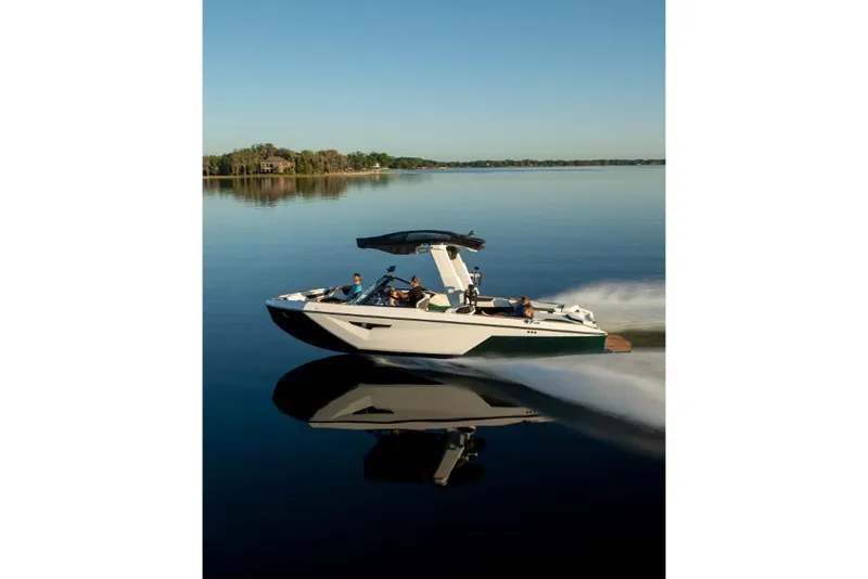 Slide: The Image of 2023 Nautique Super Air Nautique S25 cruising on a calm lake. - 47