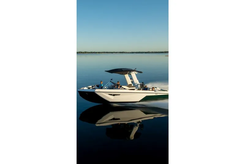 Slide: The Image of 2023 Nautique Super Air Nautique S25 boat cruising on calm water. - 48