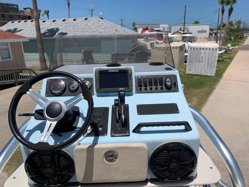Slide: The Image of 2013 SCB R24 boat dashboard with steering wheel, controls, and navigation system. - 3