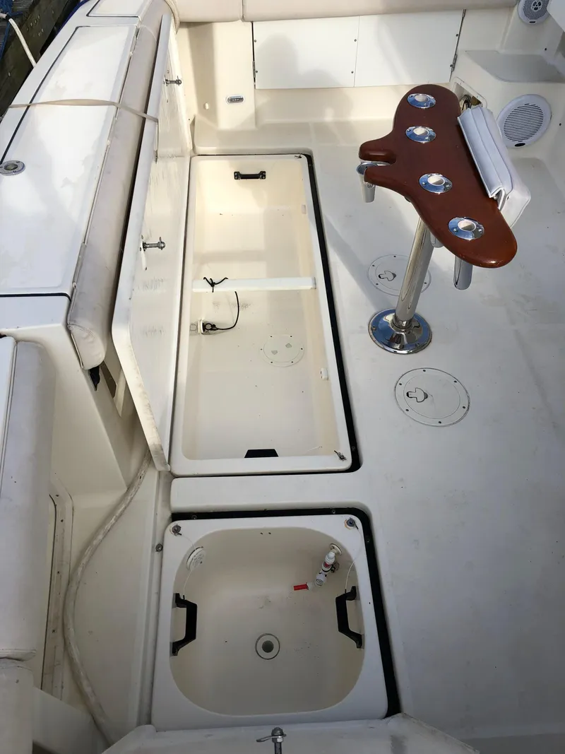 Slide: The Image of 1997 Tiara Yachts 3700 Open deck with storage compartments and fishing rod holder. - 14