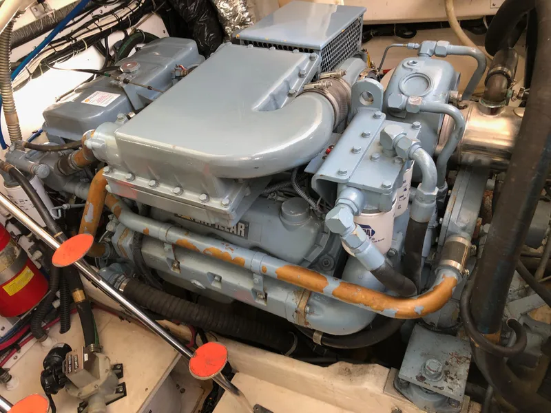 Slide: The Image of Engine of a 1997 Tiara Yachts 3700 Open, showcasing mechanical components and piping. - 20