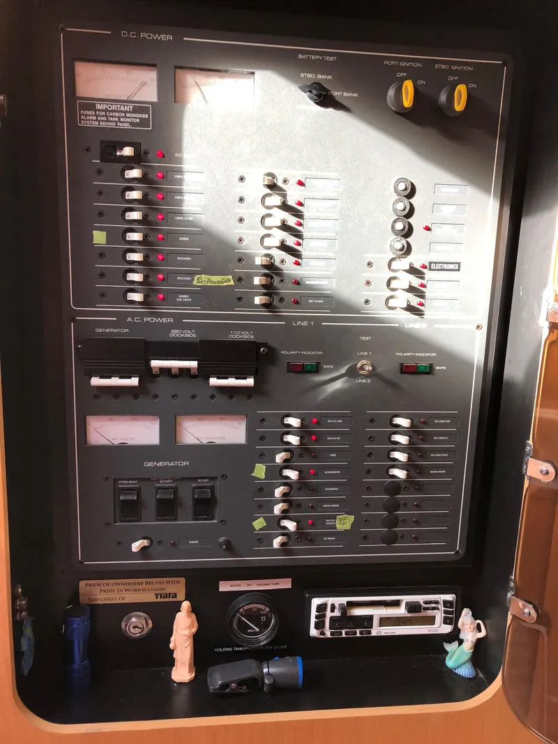 Slide: The Image of Electrical control panel of a 1997 Tiara Yachts 3700 Open, featuring various switches and gauges. - 29