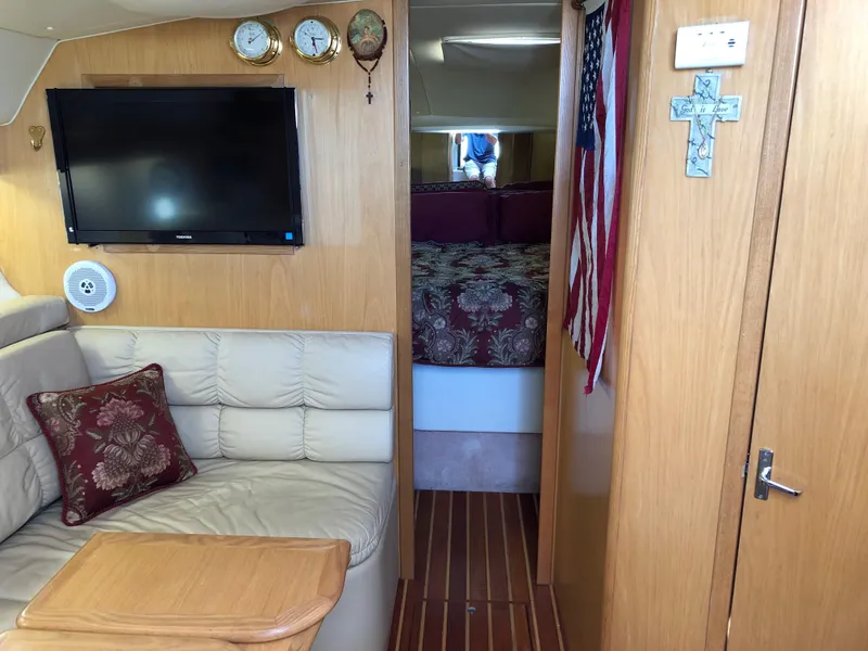 Slide: The Image of Interior of 1997 Tiara Yachts 3700 Open with cozy seating, TV, and decorative elements. - 33