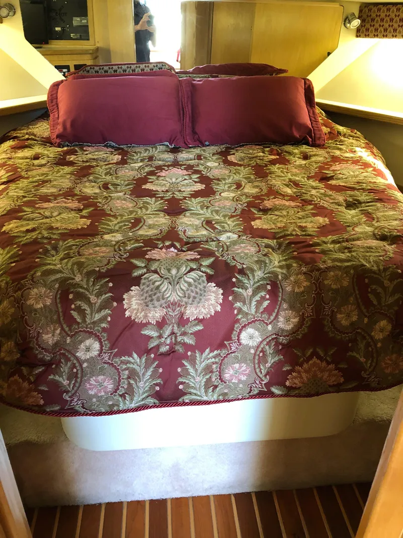 Slide: The Image of 1997 Tiara Yachts 3700 Open cabin with floral bedding and wooden accents. - 36