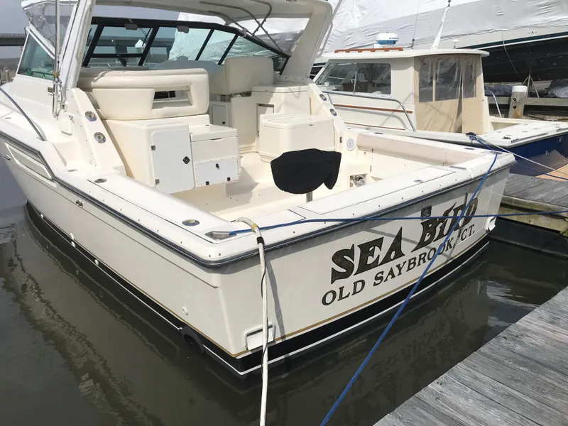 Slide: The Image of 1997 Tiara Yachts 3700 Open docked, rear view with "Sea Bird" name visible. - 6