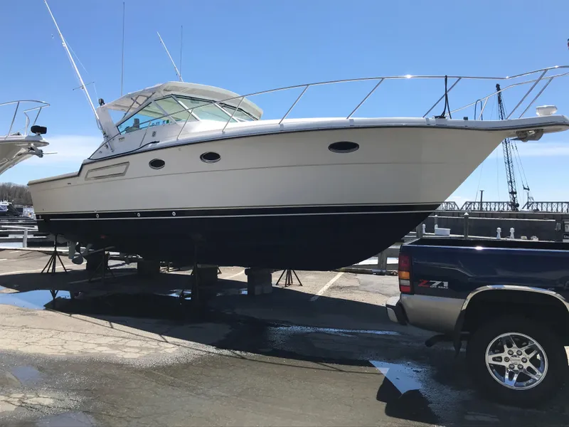Slide: The Image of 1997 Tiara Yachts 3700 Open on trailer, parked outdoors under clear blue sky. - 9