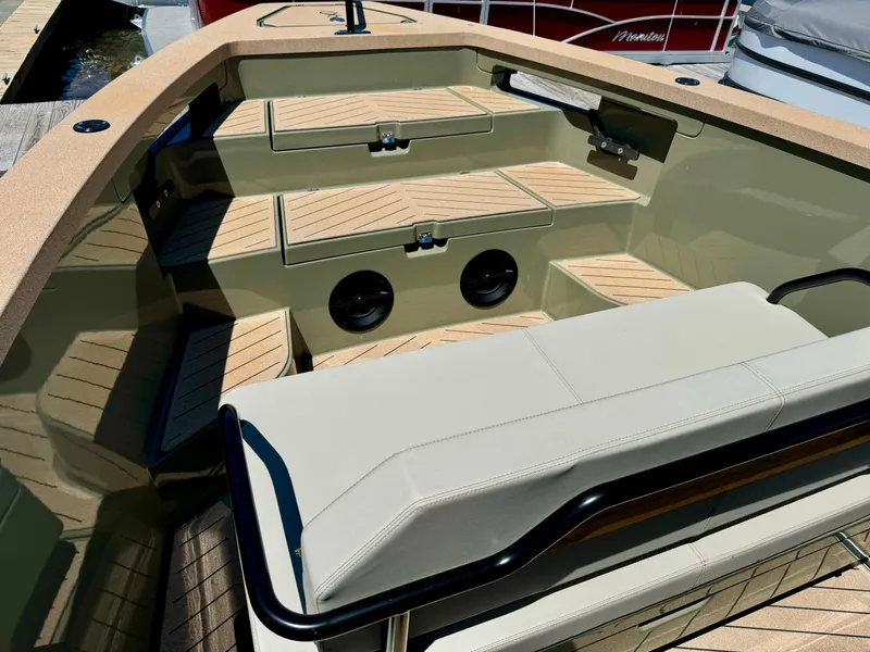 Slide: The Image of 2022 X Shore Eelex 8000 boat interior with beige seating and wooden deck. - 6