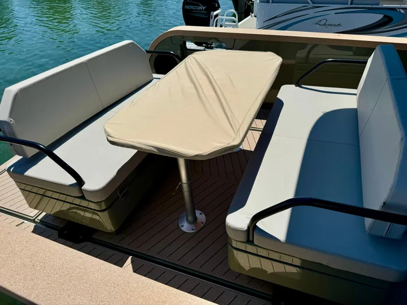 Slide: The Image of X Shore Eelex 8000 boat interior, 2022 model, featuring cushioned seating and a central table. - 7