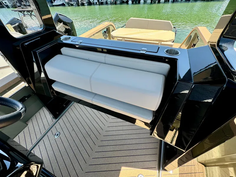 Slide: The Image of X Shore Eelex 8000 boat interior, 2022 model, featuring sleek seating and modern design. - 9