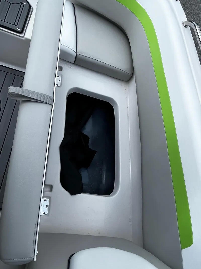 Slide: The Image of 2024 Starcraft SVX 191 boat storage compartment with green and white seating. - 9