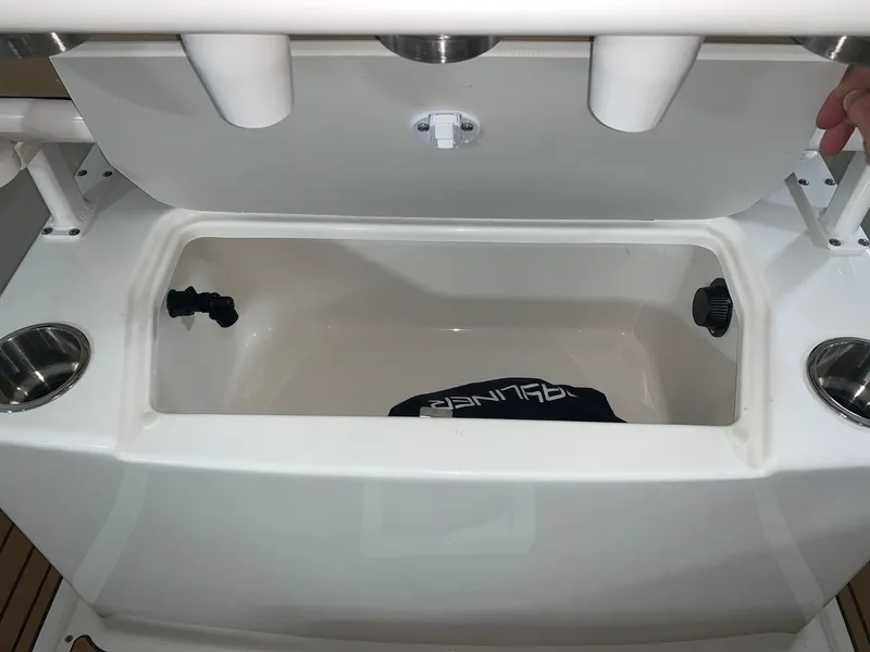 Slide: The Image of 2024 Bayliner Trophy 20CX storage compartment with cup holders and rod holders. - 10