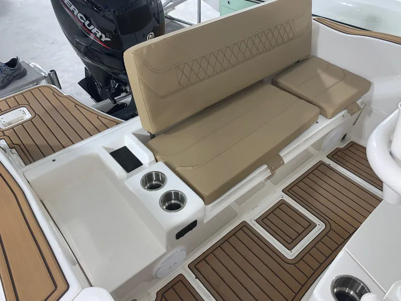Slide: The Image of 2024 Bayliner Trophy 20CX boat interior with tan seating and wood-like flooring. - 11
