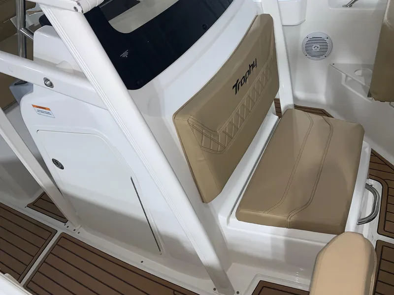 Slide: The Image of 2024 Bayliner Trophy 20CX boat interior with tan seating and wood flooring. - 14