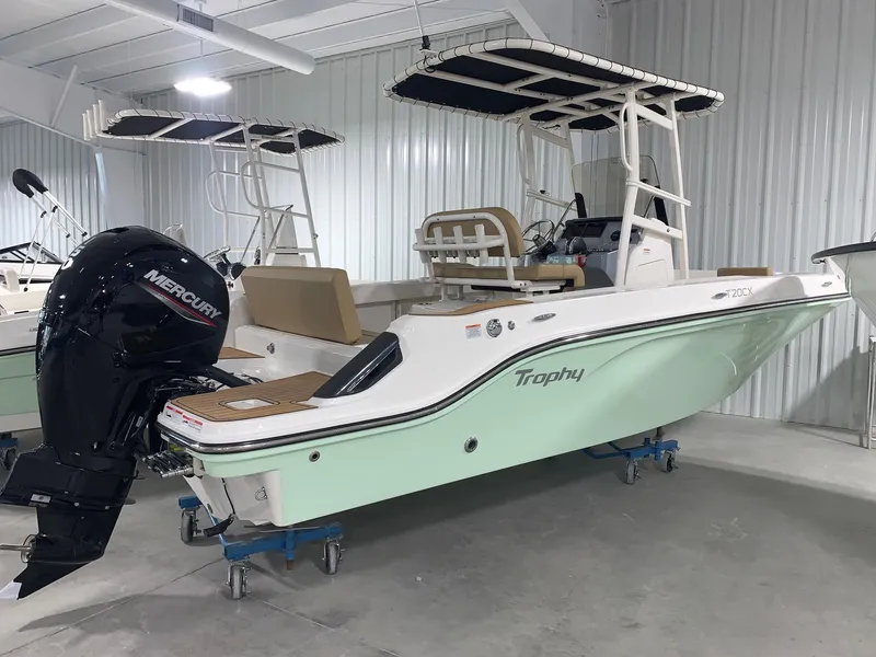 Slide: The Image of 2024 Bayliner Trophy 20CX boat in showroom with Mercury outboard motor. - 2