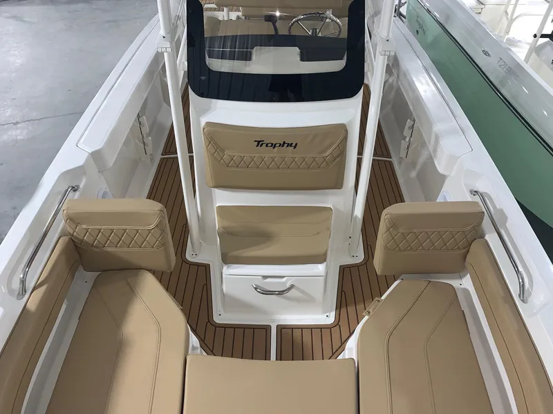Slide: The Image of 2024 Bayliner Trophy 20CX boat interior with tan seating and wood flooring. - 5