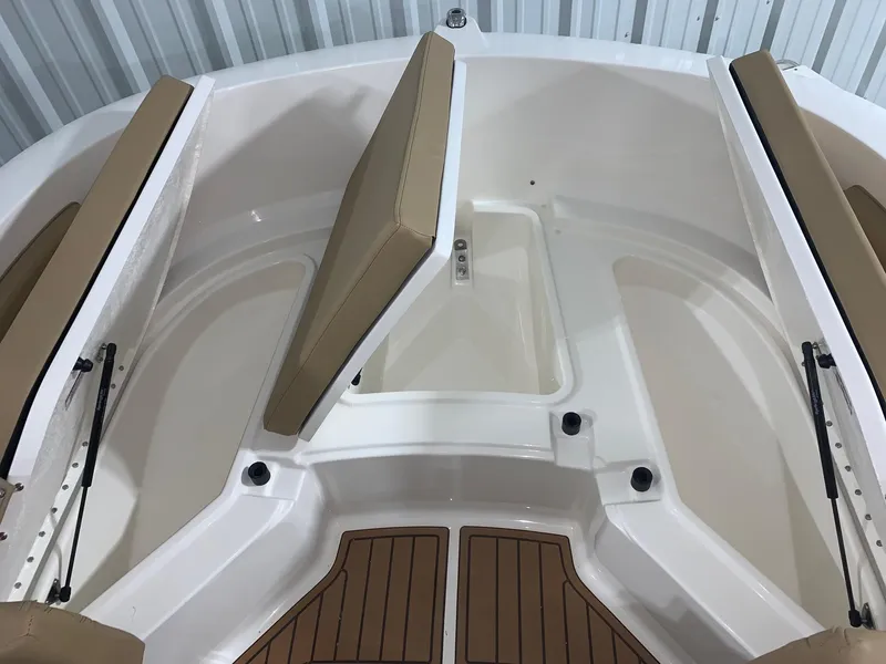 Slide: The Image of 2024 Bayliner Trophy 20CX boat interior with cushioned seating and storage compartments. - 15