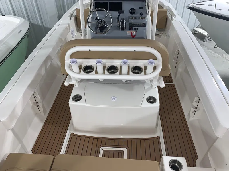 Slide: The Image of 2024 Bayliner Trophy 20CX boat interior with rod holders and steering console. - 4