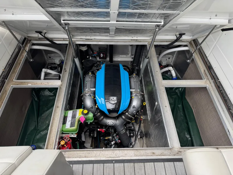 Slide: The Image of Engine compartment of 2022 Montara SURF BOSS 25 boat, featuring PCM engine. - 14