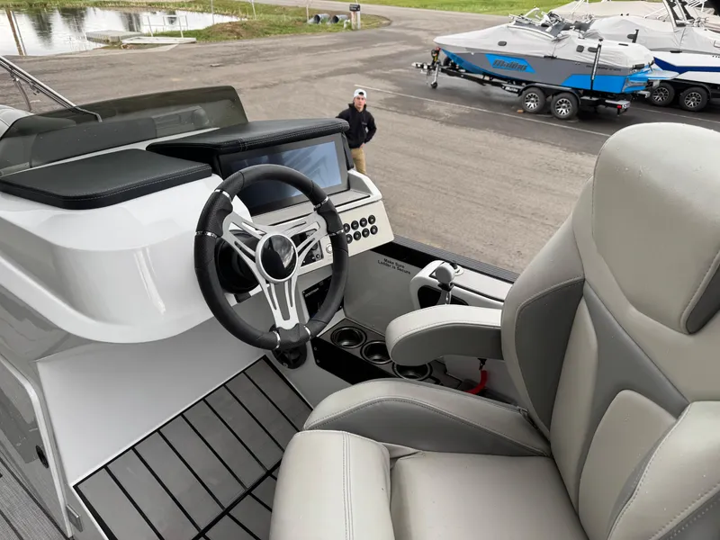 Slide: The Image of 2022 Montara SURF BOSS 25 boat interior with steering wheel and control panel. - 8