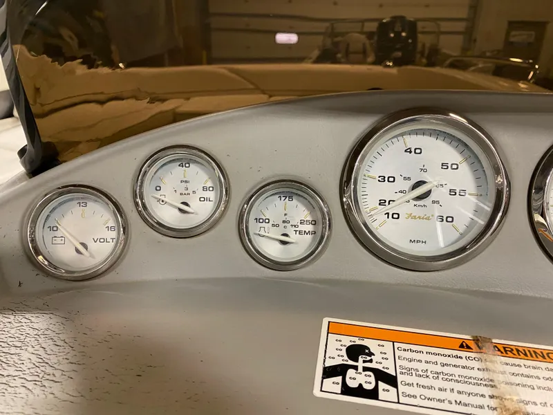 Slide: The Image of 2011 Bayliner 197 boat dashboard with volt, oil, temperature, and speed gauges. - 11
