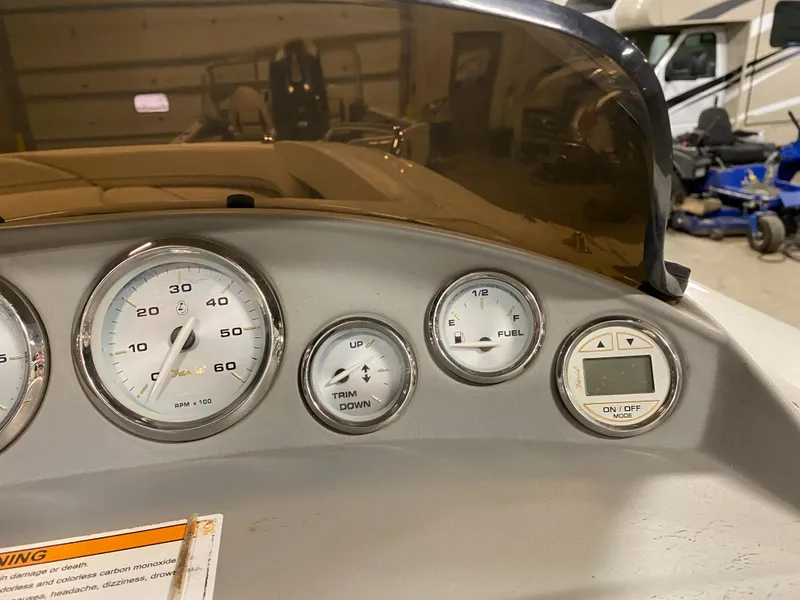 Slide: The Image of Dashboard of a 2011 Bayliner 197 boat with gauges and controls. - 12