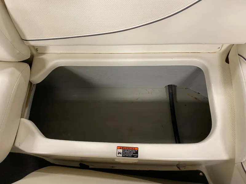 Slide: The Image of Storage compartment in a 2011 Bayliner 197 boat with white interior. - 14