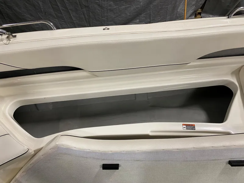Slide: The Image of Bayliner 197 2011 boat interior storage compartment with white upholstery. - 15