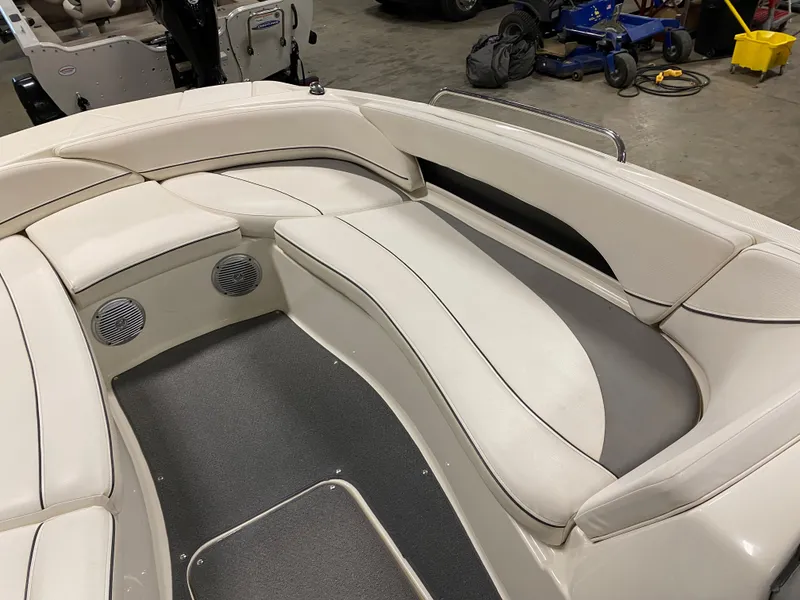 Slide: The Image of 2011 Bayliner 197 boat interior with white cushioned seating and built-in speakers. - 20