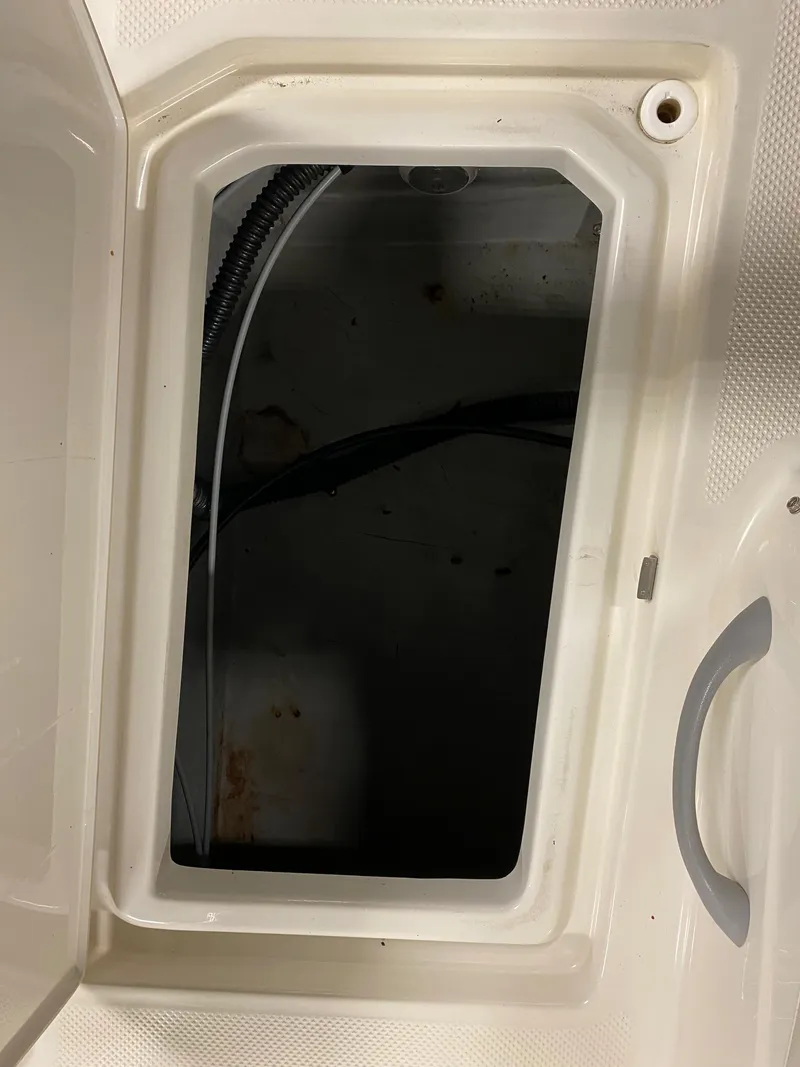 Slide: The Image of Open storage compartment on a 2011 Bayliner 197 boat. - 24
