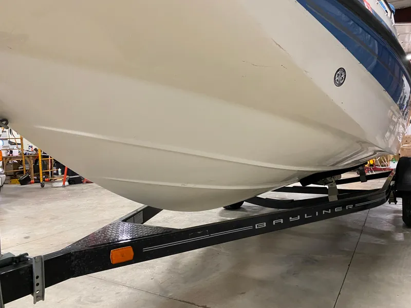 Slide: The Image of 2011 Bayliner 197 boat on trailer in a garage. - 25